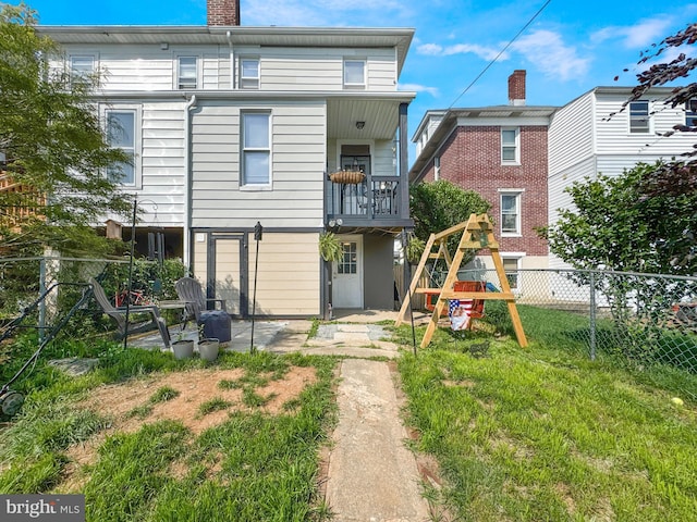 268 N Main St, Red Lion, PA 17356 - back of house with a playground, a chimney, and a patio area