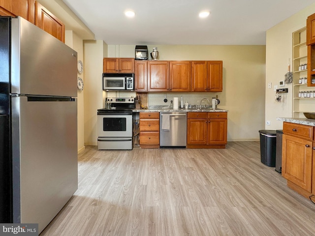 268 N Main St, Red Lion, PA 17356 - kitchen with appliances with stainless steel finishes, brown cabinetry, light wood-type flooring, and recessed lighting