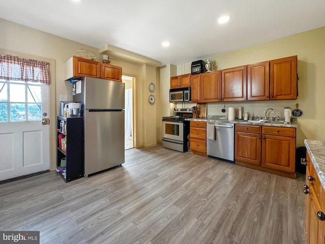 268 N Main St, Red Lion, PA 17356 - kitchen with appliances with stainless steel finishes, brown cabinets, light wood finished floors, and recessed lighting