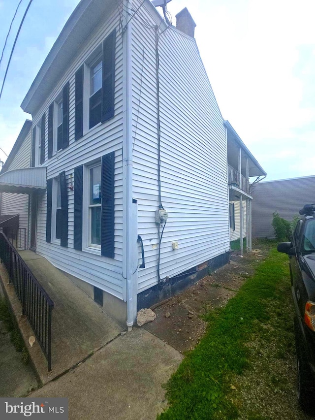 118 S 3rd St, Pottsville, PA 17901 - view of side of property with crawl space and a chimney