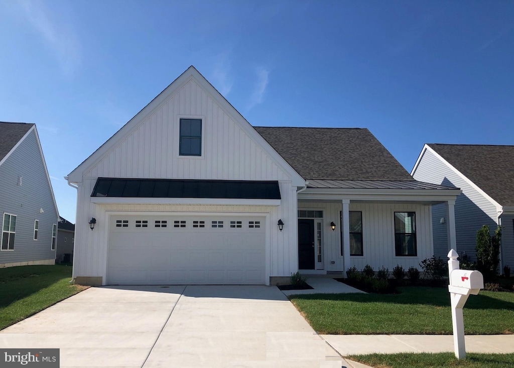 126 Fairmont Ln, Dover, DE 19904 - modern farmhouse featuring a standing seam roof, a front lawn, board and batten siding, and concrete driveway