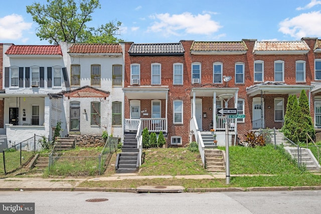 16 N Morley St, Baltimore, MD 21229 - view of property featuring a tiled roof and stairs