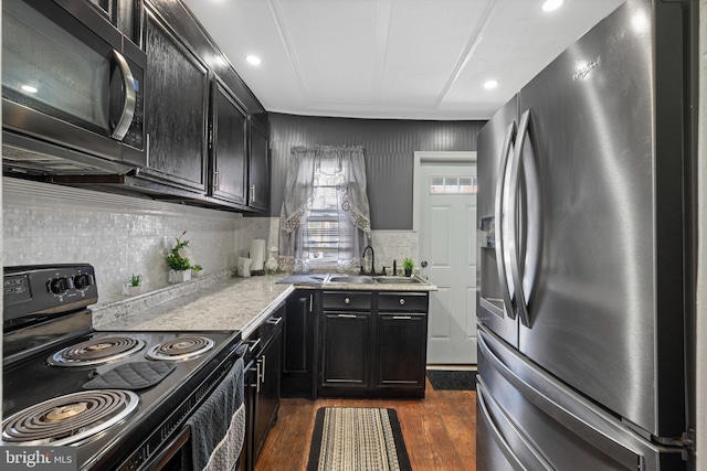 16 N Morley St, Baltimore, MD 21229 - kitchen featuring stainless steel fridge with ice dispenser, black range with electric cooktop, light countertops, dark wood-type flooring, and dark cabinetry