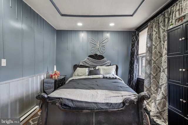 16 N Morley St, Baltimore, MD 21229 - bedroom with a baseboard heating unit, a decorative wall, and recessed lighting