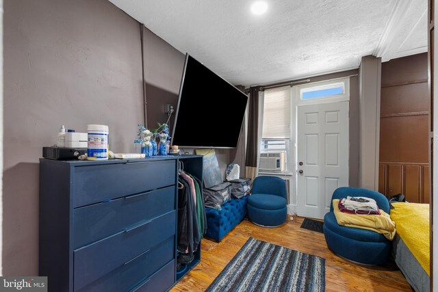 16 N Morley St, Baltimore, MD 21229 - living area with a textured ceiling, light wood-style floors, and cooling unit
