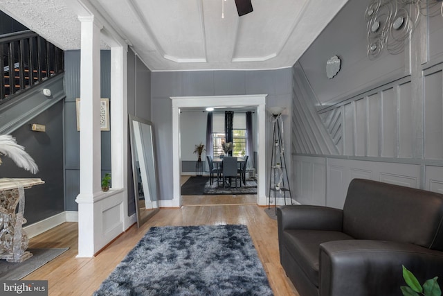 16 N Morley St, Baltimore, MD 21229 - living area with a decorative wall, wood finished floors, ceiling fan, and ornate columns