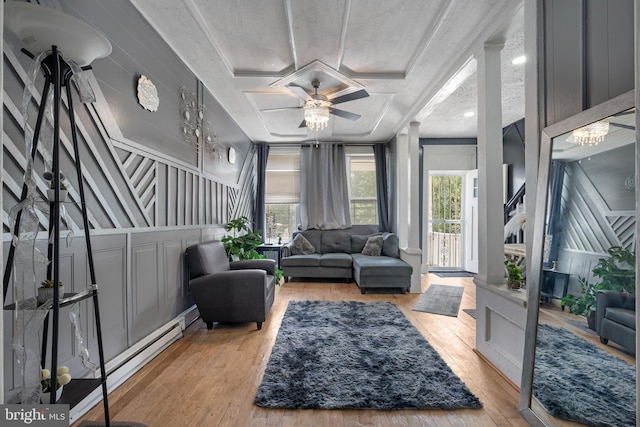 16 N Morley St, Baltimore, MD 21229 - living area with healthy amount of natural light, wood finished floors, ceiling fan, and a decorative wall