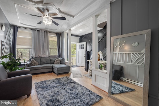 16 N Morley St, Baltimore, MD 21229 - living room featuring plenty of natural light, ceiling fan, wood finished floors, a baseboard radiator, and a decorative wall