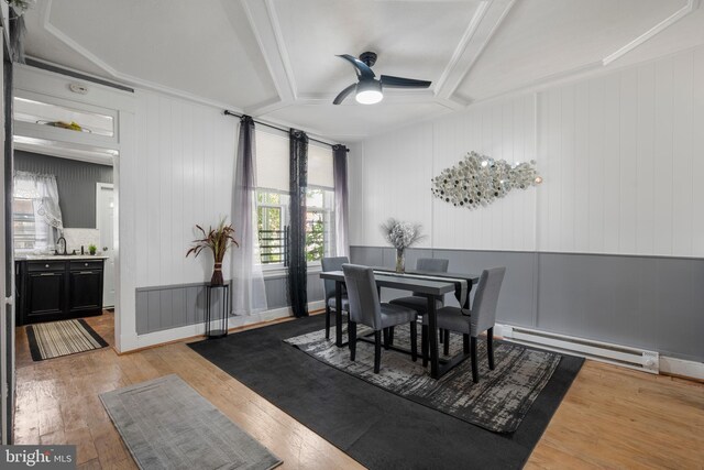 16 N Morley St, Baltimore, MD 21229 - dining area with a baseboard heating unit, ceiling fan, light wood finished floors, and beamed ceiling
