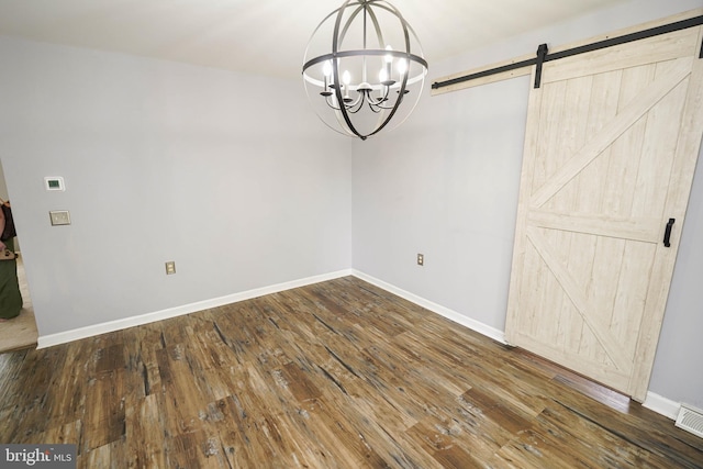 612 S Division St, Fruitland, MD 21826 - unfurnished dining area featuring a barn door, a chandelier, and hardwood / wood-style floors