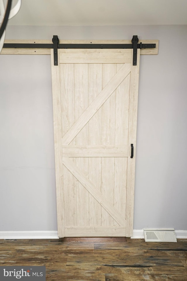 612 S Division St, Fruitland, MD 21826 - detailed view of a barn door and wood finished floors