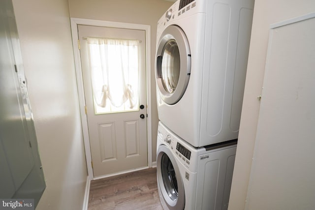 612 S Division St, Fruitland, MD 21826 - laundry area featuring stacked washer / drying machine and wood finished floors