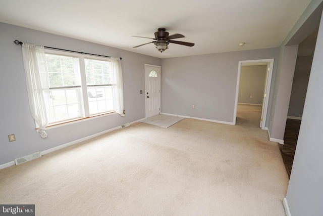 612 S Division St, Fruitland, MD 21826 - unfurnished living room featuring ceiling fan and light colored carpet