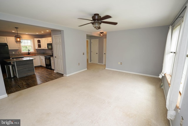 612 S Division St, Fruitland, MD 21826 - unfurnished living room with dark carpet, a ceiling fan, and recessed lighting