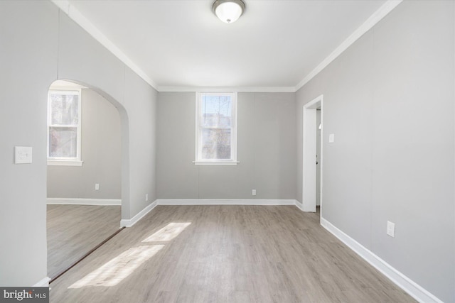 5248 Cordelia Ave, Baltimore, MD 21215 - unfurnished room with arched walkways, light wood-style flooring, and ornamental molding