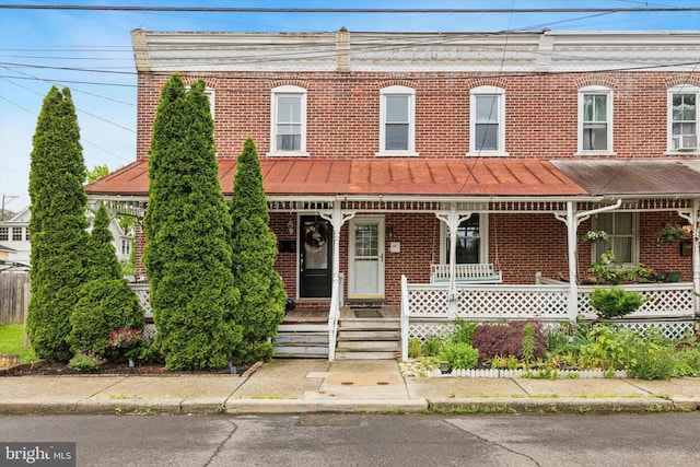 252 N 3rd St, North Wales, PA 19454 - view of front facade with brick siding, a porch, and a standing seam roof