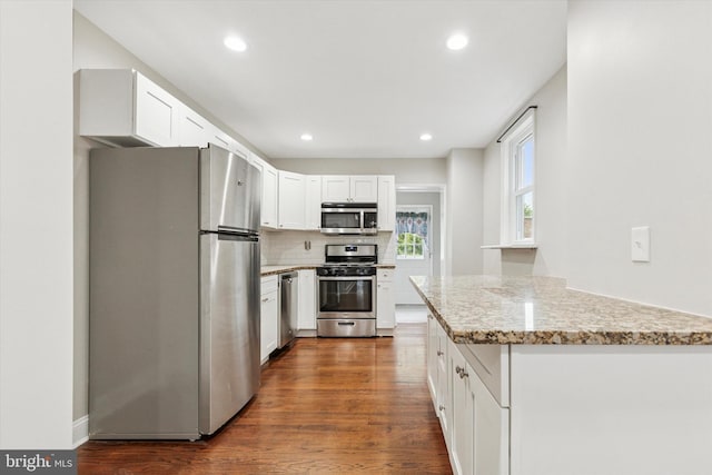 252 N 3rd St, North Wales, PA 19454 - kitchen with appliances with stainless steel finishes, dark wood-style flooring, tasteful backsplash, white cabinets, and recessed lighting