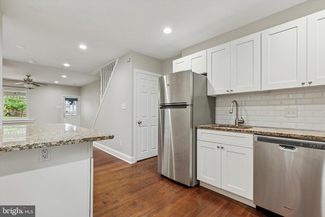 252 N 3rd St, North Wales, PA 19454 - kitchen featuring appliances with stainless steel finishes, light stone countertops, dark wood-type flooring, backsplash, and white cabinetry