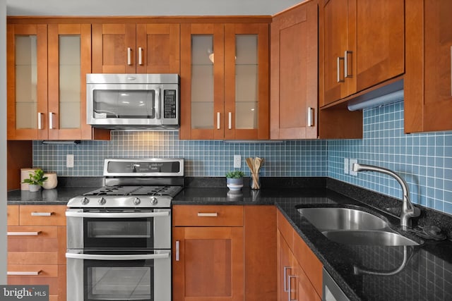 3515 Washington Blvd Unit 316, Arlington, VA 22201 - kitchen with appliances with stainless steel finishes, brown cabinetry, and backsplash