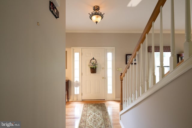 5900 Wayside Dr, Macungie, PA 18062 - entryway featuring healthy amount of natural light, stairs, light wood finished floors, and crown molding