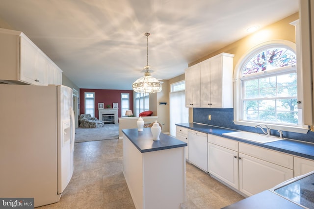 5900 Wayside Dr, Macungie, PA 18062 - kitchen featuring white appliances, healthy amount of natural light, dark countertops, and a center island
