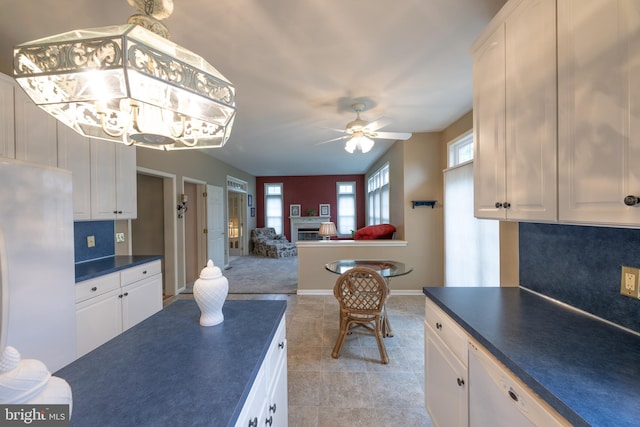 5900 Wayside Dr, Macungie, PA 18062 - kitchen with white appliances, dark countertops, a ceiling fan, white cabinets, and backsplash