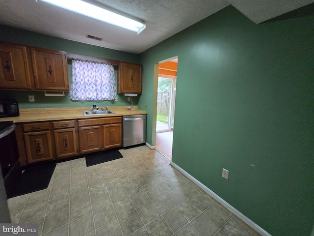 14 Riverside Run Dr, Indian Head, MD 20640 - kitchen with stainless steel dishwasher, black microwave, light countertops, range with electric cooktop, and a textured ceiling