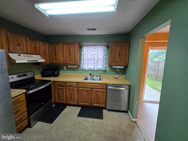 14 Riverside Run Dr, Indian Head, MD 20640 - kitchen featuring under cabinet range hood, appliances with stainless steel finishes, light countertops, and brown cabinets