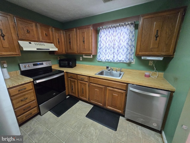 14 Riverside Run Dr, Indian Head, MD 20640 - kitchen featuring stainless steel appliances, under cabinet range hood, light countertops, and brown cabinetry