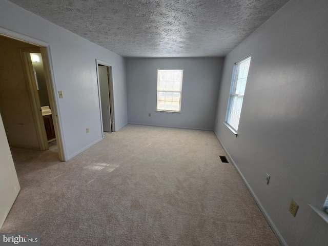 14 Riverside Run Dr, Indian Head, MD 20640 - spare room featuring a textured ceiling and light carpet
