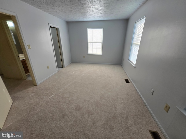 14 Riverside Run Dr, Indian Head, MD 20640 - unfurnished bedroom with a textured ceiling and light colored carpet