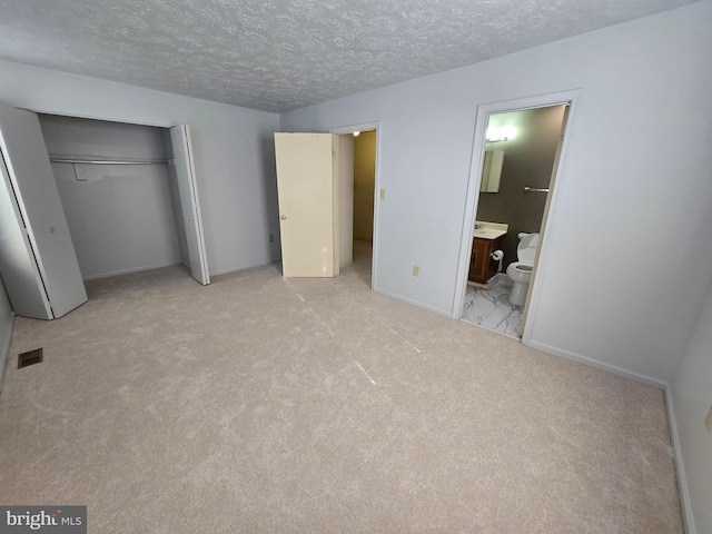 14 Riverside Run Dr, Indian Head, MD 20640 - unfurnished bedroom featuring a closet, a textured ceiling, carpet flooring, and connected bathroom