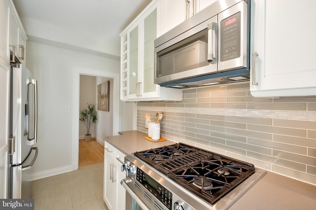 3100 Connecticut Ave NW Unit 434, Washington, DC 20008 - kitchen featuring appliances with stainless steel finishes, white cabinetry, and light countertops