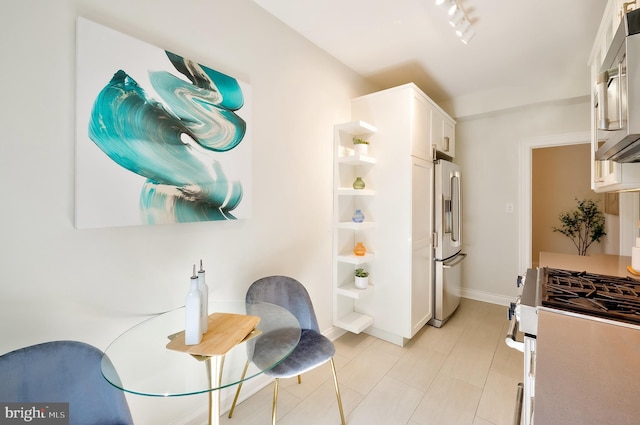 3100 Connecticut Ave NW Unit 434, Washington, DC 20008 - kitchen featuring appliances with stainless steel finishes, open shelves, white cabinets, light tile patterned flooring, and rail lighting