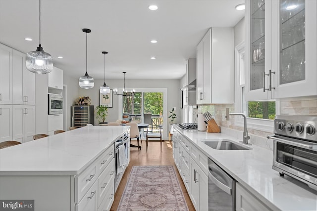 14731 Conway Dr, Manassas, VA 20112 - kitchen with appliances with stainless steel finishes, a center island, recessed lighting, white cabinets, and light stone countertops