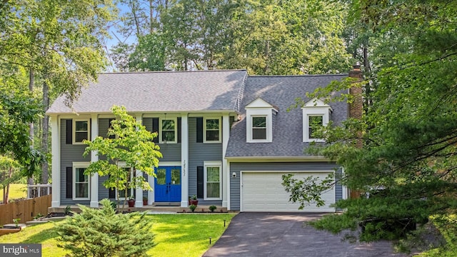 14731 Conway Dr, Manassas, VA 20112 - view of front of property featuring asphalt driveway, a shingled roof, a chimney, and a garage
