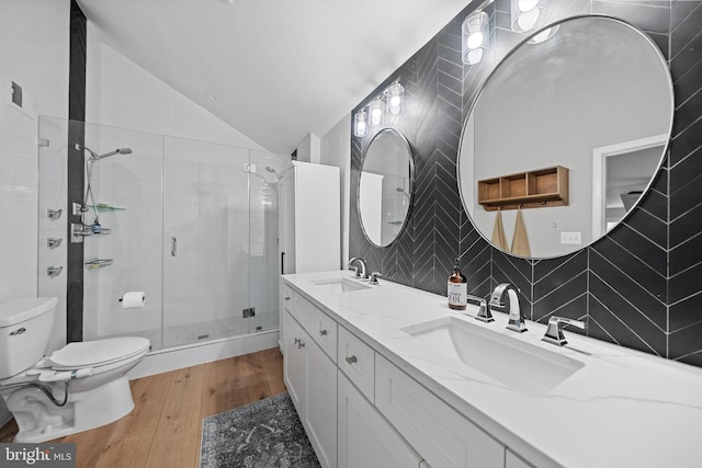 14731 Conway Dr, Manassas, VA 20112 - bathroom featuring a shower stall, wood finished floors, double vanity, vaulted ceiling, and tasteful backsplash