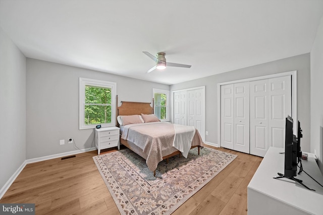 14731 Conway Dr, Manassas, VA 20112 - bedroom with multiple closets, light wood-type flooring, and a ceiling fan