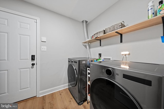 14731 Conway Dr, Manassas, VA 20112 - washroom with washing machine and clothes dryer and light wood finished floors