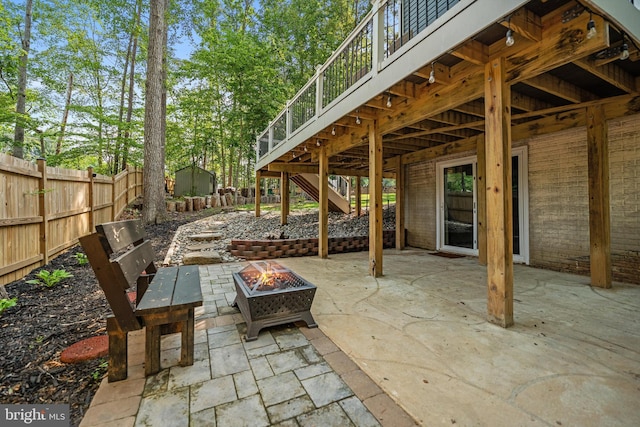 14731 Conway Dr, Manassas, VA 20112 - view of patio featuring a fire pit, stairway, and a storage shed