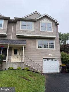 654 Woodspring Dr, Warrington, PA 18976 - view of front of property with an attached garage, a front yard, asphalt driveway, and a porch