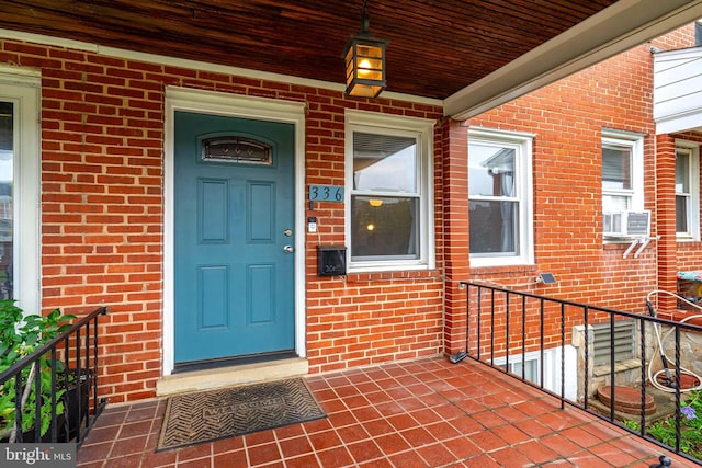 336 Imla St, Baltimore, MD 21224 - doorway to property with brick siding and a porch