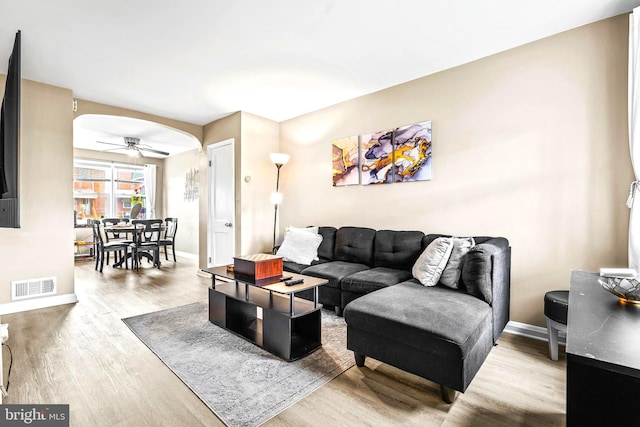 336 Imla St, Baltimore, MD 21224 - living room featuring wood finished floors, arched walkways, and a ceiling fan