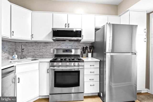 336 Imla St, Baltimore, MD 21224 - kitchen featuring stainless steel appliances, light countertops, and white cabinets