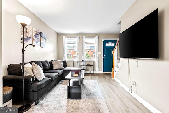 336 Imla St, Baltimore, MD 21224 - living room featuring light wood-style floors and stairway