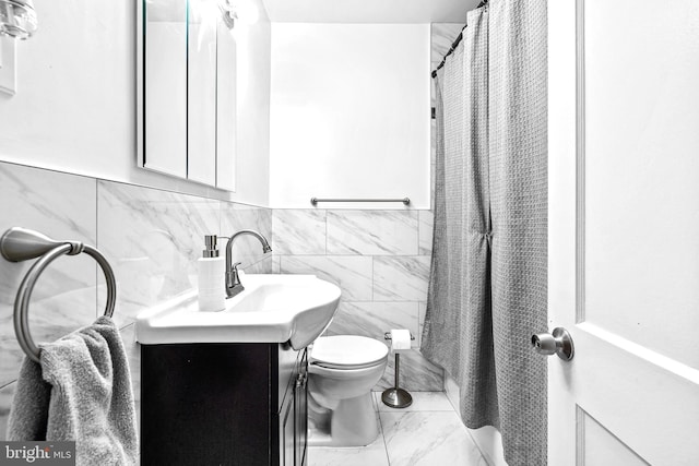 336 Imla St, Baltimore, MD 21224 - full bath featuring vanity, marble finish flooring, tile walls, a wainscoted wall, and a shower with shower curtain