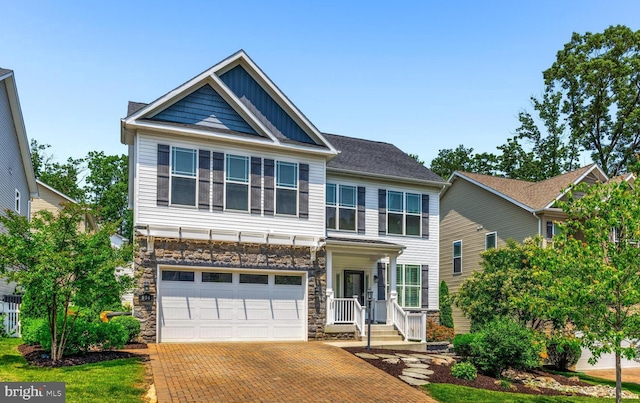 806 Dunfer Hill Rd, Severna Park, MD 21146 - craftsman-style home featuring stone siding, an attached garage, decorative driveway, and board and batten siding