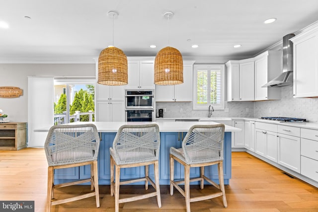 806 Dunfer Hill Rd, Severna Park, MD 21146 - kitchen with wall chimney exhaust hood, stainless steel appliances, light countertops, white cabinetry, and crown molding