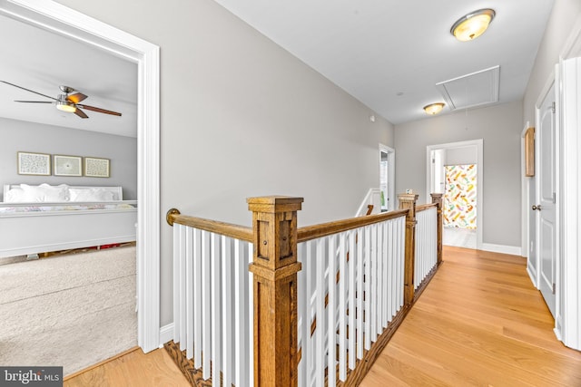 806 Dunfer Hill Rd, Severna Park, MD 21146 - hallway featuring attic access, light wood-style flooring, and an upstairs landing