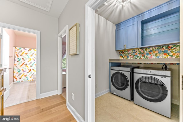806 Dunfer Hill Rd, Severna Park, MD 21146 - laundry area featuring washing machine and clothes dryer, cabinet space, and light tile patterned floors